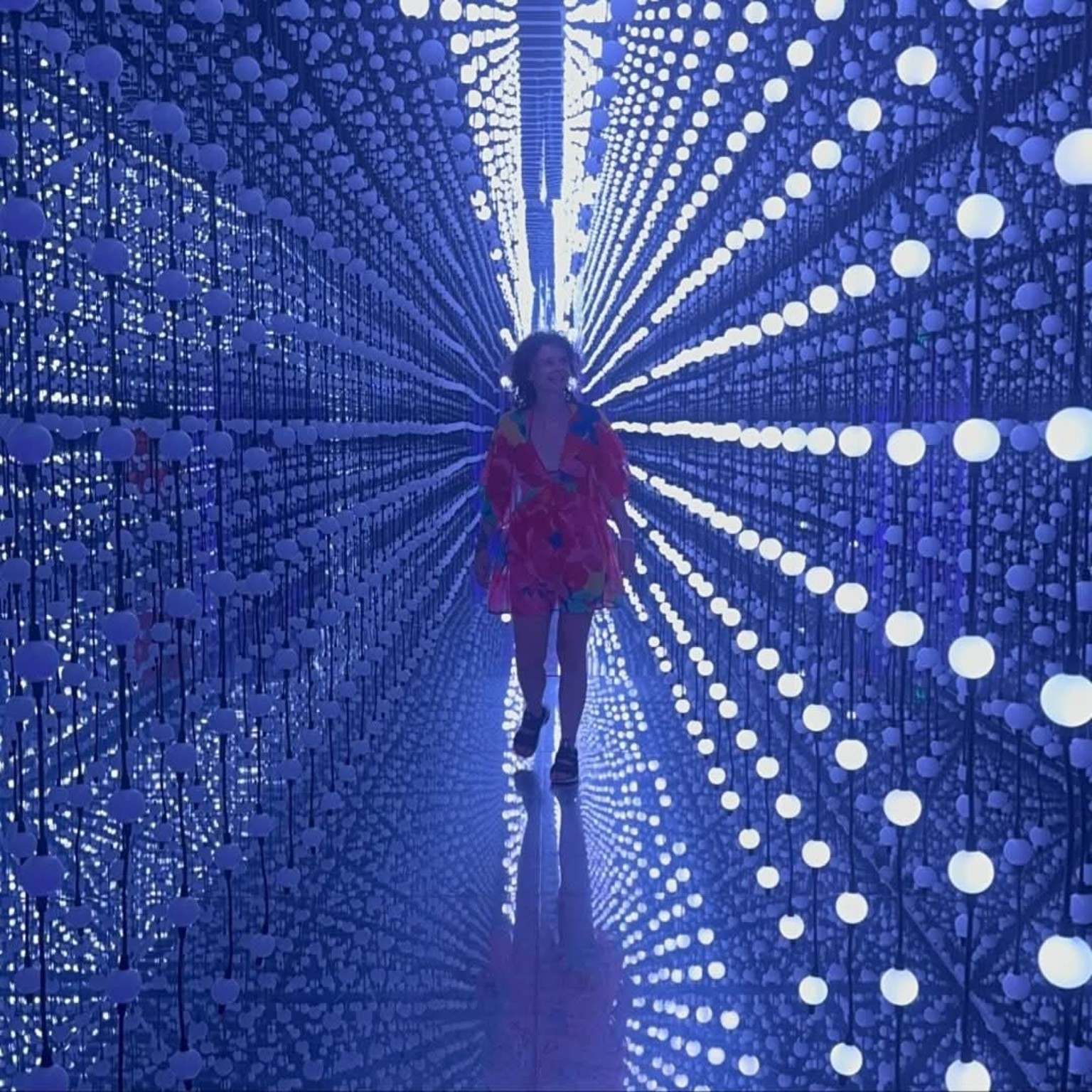 Paulina walking through an immersive light installation